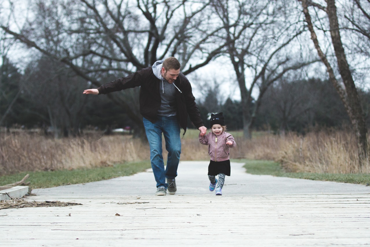 Dad running with daughter. Getting full child custody Australia.
