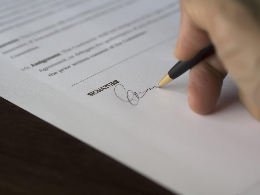 How valid are prenuptial agreements in Australia? Man signing agreement.